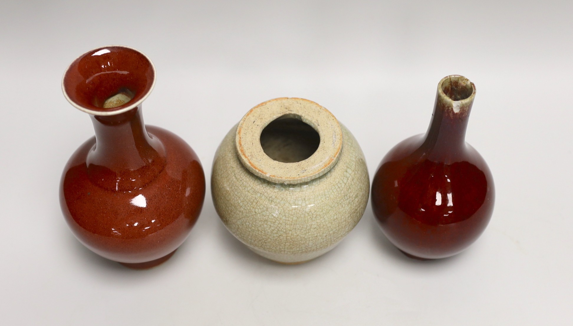 Two Chinese sang de boeuf vases and a crackle glaze jar, tallest 17cm